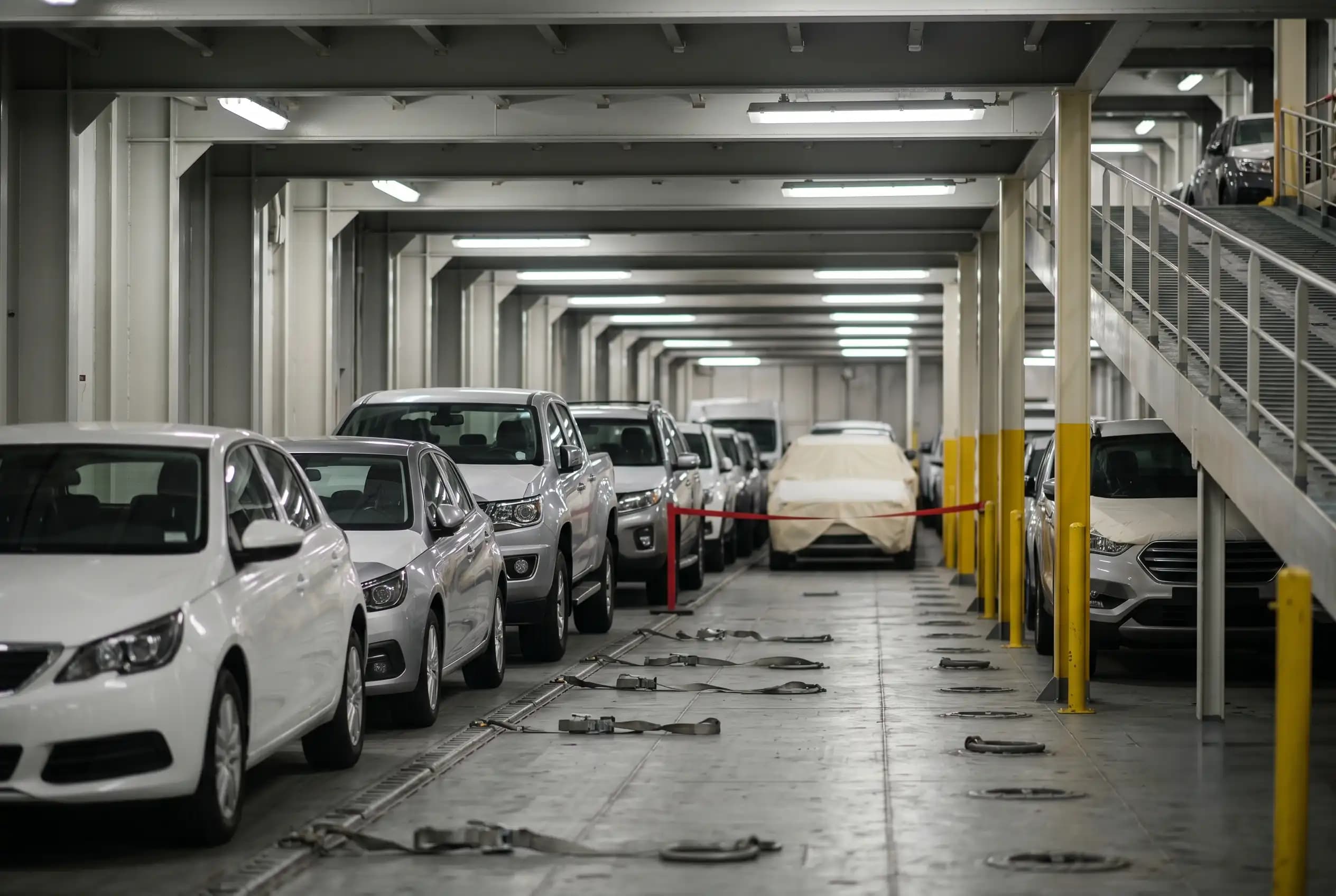 Car driving up the ramp into the enclosed deck of a Matson roll-on/roll-off vessel